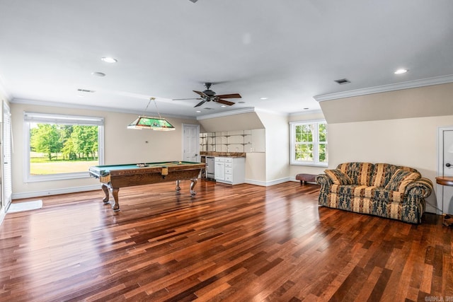 recreation room with dark wood-style floors, visible vents, and crown molding