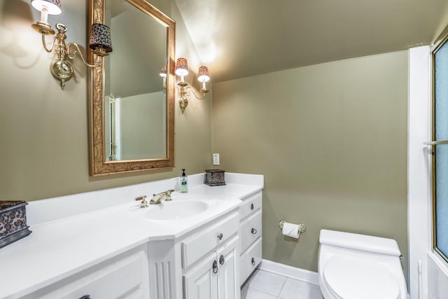 bathroom with baseboards, vanity, toilet, and tile patterned floors