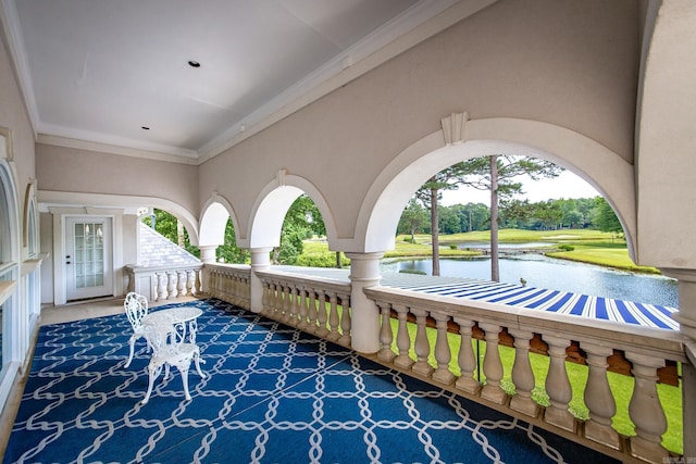 view of patio / terrace with a water view and covered porch