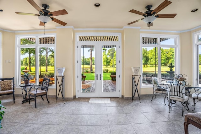 entryway featuring tile patterned floors, ornamental molding, a ceiling fan, and french doors