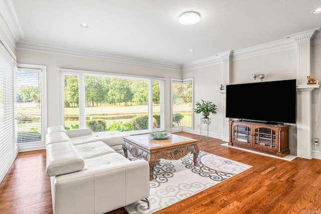 living room with baseboards, ornamental molding, wood finished floors, and recessed lighting