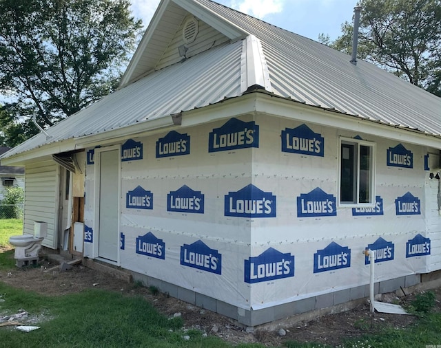 view of side of home with metal roof