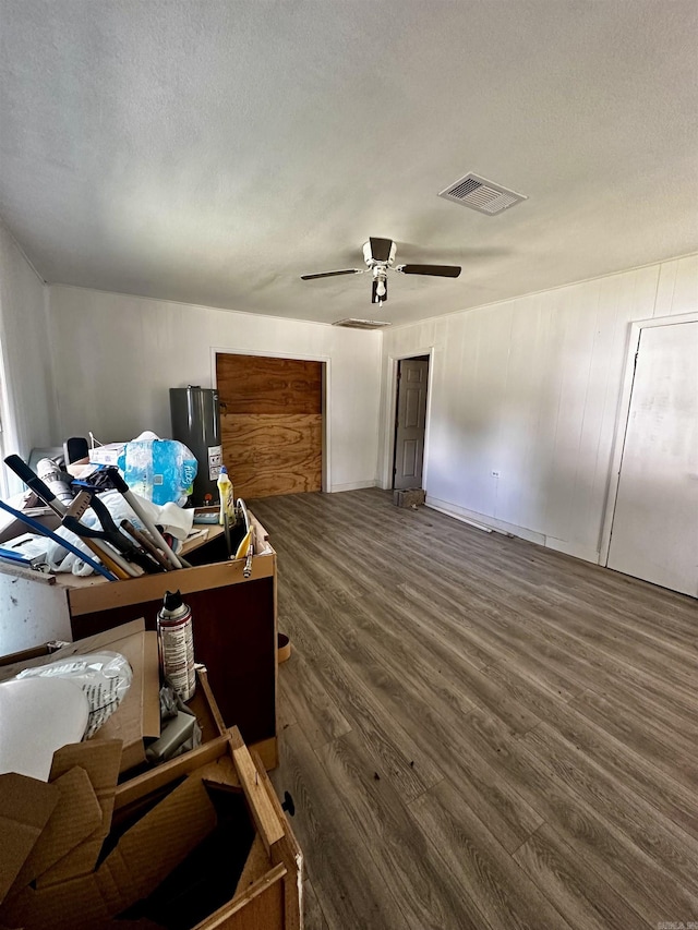 interior space with visible vents, ceiling fan, a textured ceiling, and wood finished floors