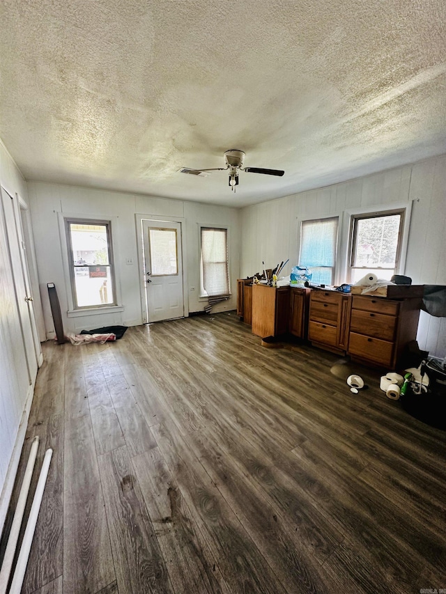 interior space with dark wood-style floors, ceiling fan, and a textured ceiling