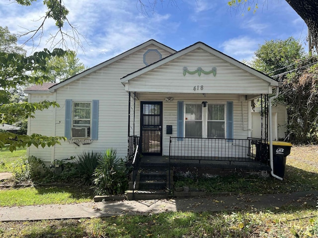 bungalow-style house with a porch and cooling unit