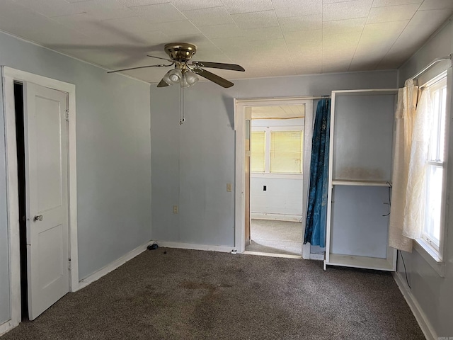 unfurnished bedroom with carpet, baseboards, and a ceiling fan