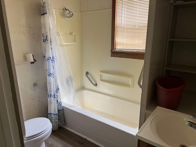 bathroom with shower / tub combo with curtain, a sink, toilet, and wood finished floors