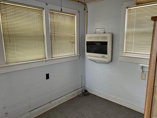 spare room featuring carpet floors and heating unit