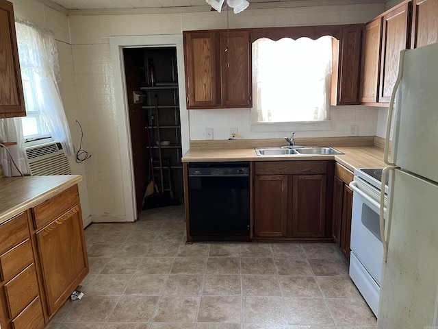 kitchen with white appliances, decorative backsplash, brown cabinets, light countertops, and a sink