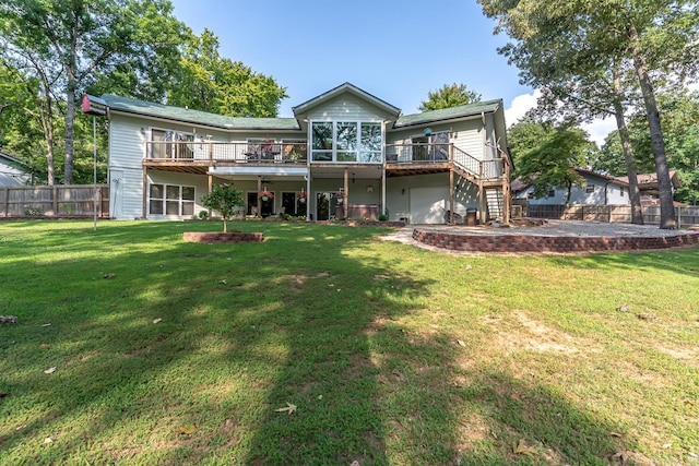 rear view of house with a yard, a deck, and a patio