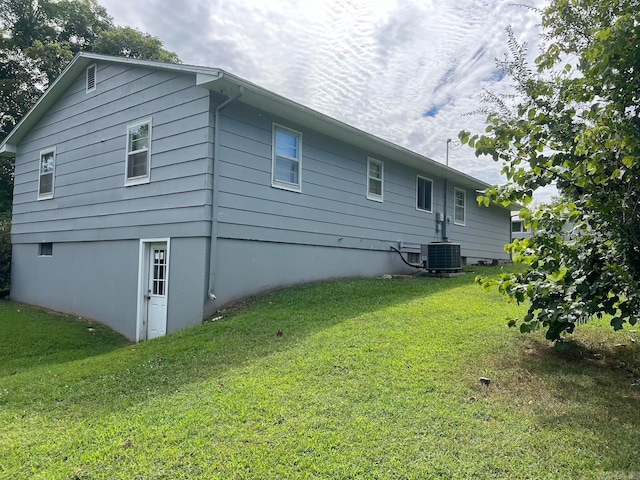 back of house with a yard and cooling unit