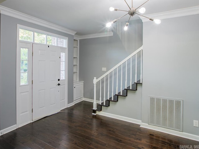 entrance foyer with dark hardwood / wood-style floors, crown molding, and a notable chandelier