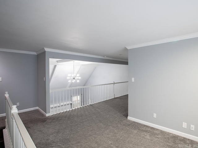 empty room featuring lofted ceiling, carpet flooring, an inviting chandelier, and crown molding