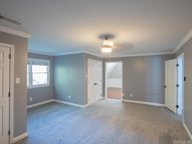 carpeted empty room with ceiling fan and crown molding