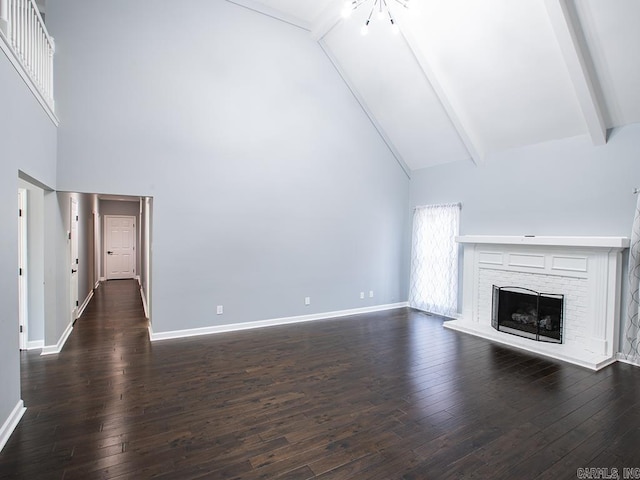 unfurnished living room with high vaulted ceiling, dark hardwood / wood-style floors, beam ceiling, and a brick fireplace