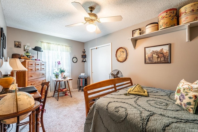 bedroom featuring ceiling fan, a textured ceiling, and carpet floors