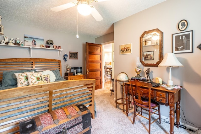 carpeted bedroom featuring ceiling fan and a textured ceiling