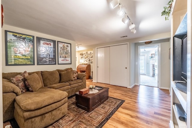 living room with track lighting and hardwood / wood-style floors