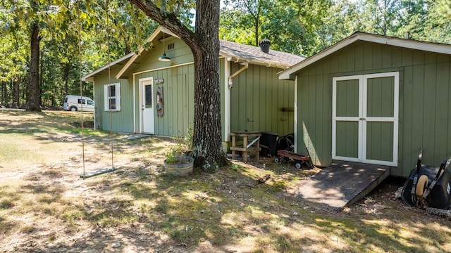 rear view of property with a shed