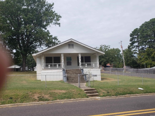 bungalow with a front yard and a porch