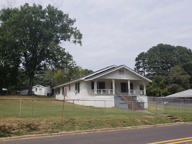 view of front of home with a front yard and covered porch