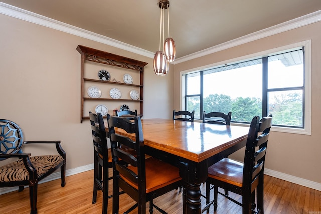 dining room with light hardwood / wood-style floors and ornamental molding