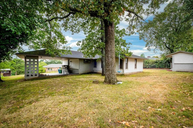 back of house with a lawn