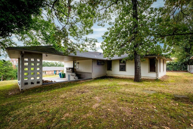 back of house featuring a lawn