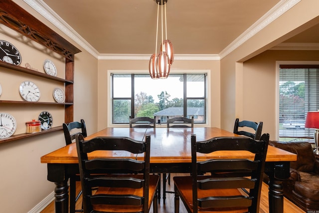 dining room with ornamental molding, a chandelier, and hardwood / wood-style flooring