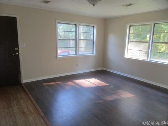 unfurnished room featuring dark wood-type flooring