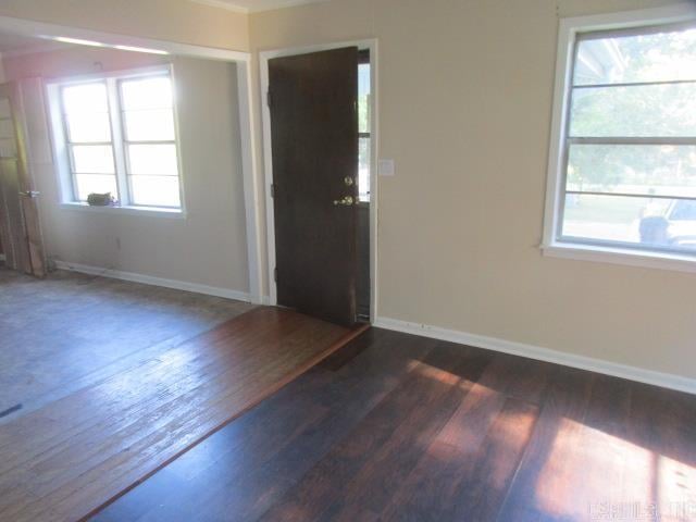 interior space with a wealth of natural light and dark wood-type flooring