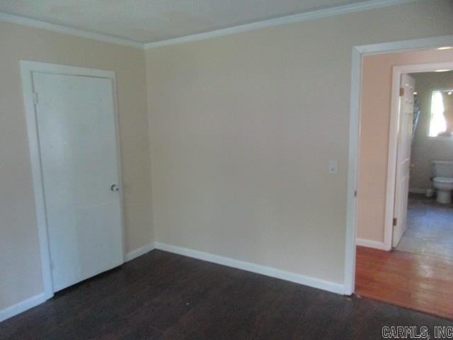 spare room featuring ornamental molding and hardwood / wood-style floors