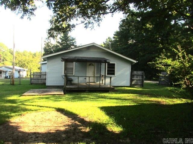 back of house with a yard and a wooden deck