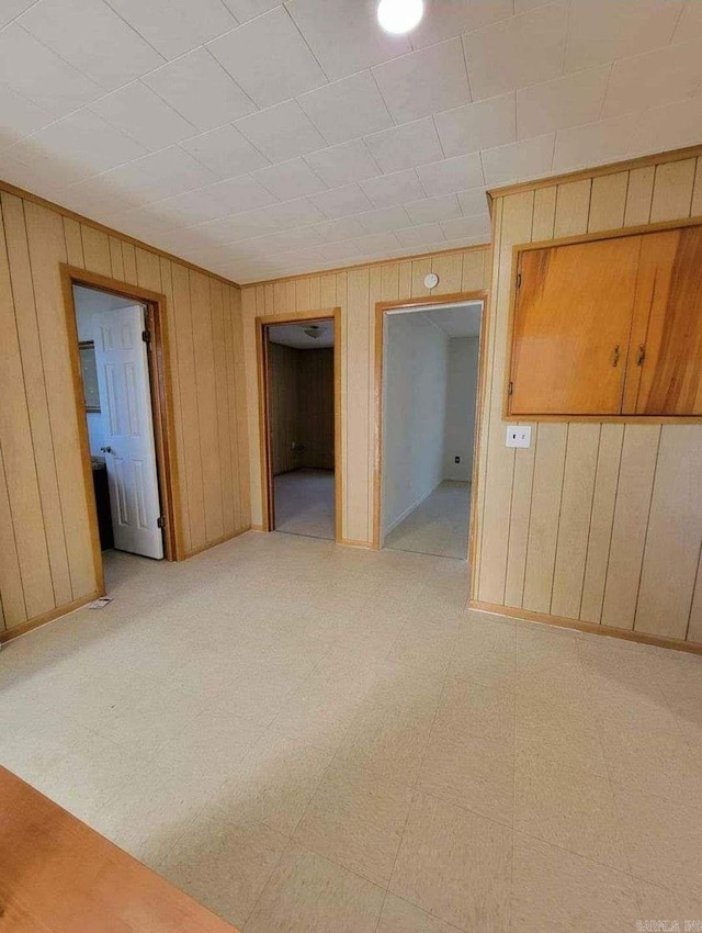 empty room featuring wood walls