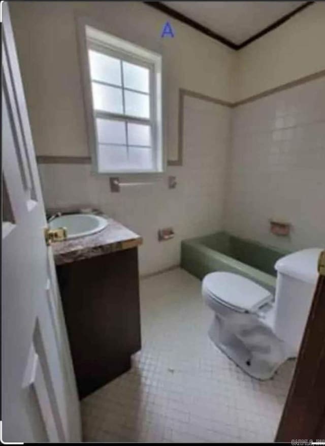 bathroom with vanity, toilet, a bath, and tile patterned floors