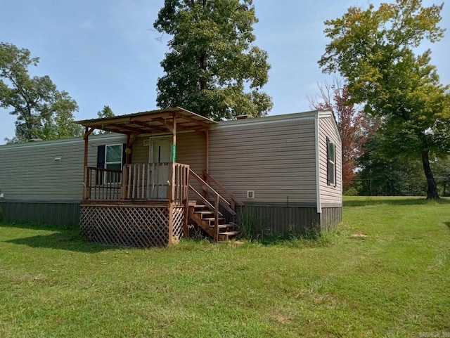 rear view of house featuring a yard