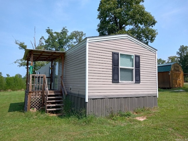 view of side of property featuring a storage shed and a lawn