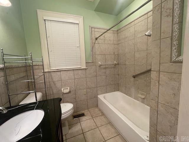 full bathroom featuring vanity, shower / washtub combination, tile patterned floors, toilet, and tile walls