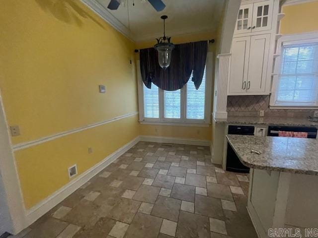 kitchen featuring light stone countertops, baseboards, white cabinets, crown molding, and tasteful backsplash