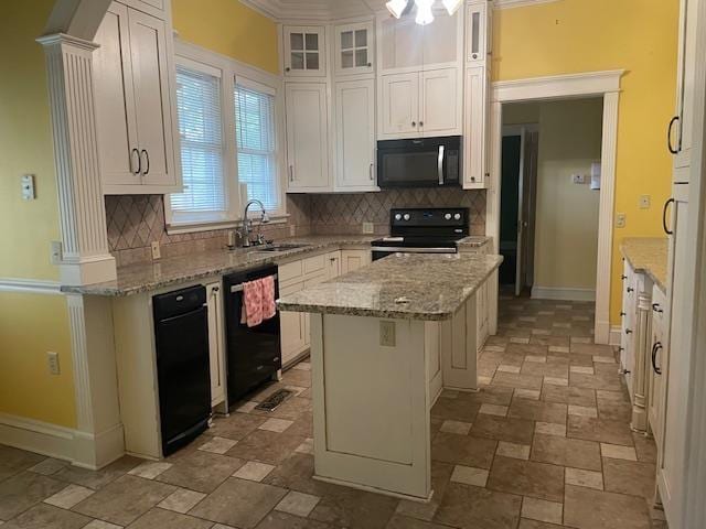 kitchen featuring a center island, white cabinets, black appliances, and a sink