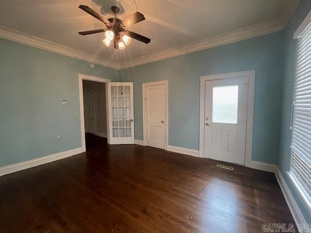 interior space with wood finished floors, baseboards, ceiling fan, crown molding, and a wealth of natural light