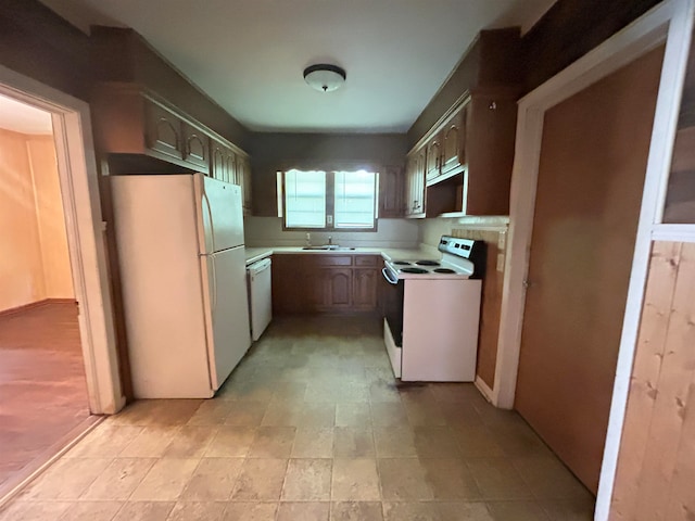 kitchen featuring white appliances and sink