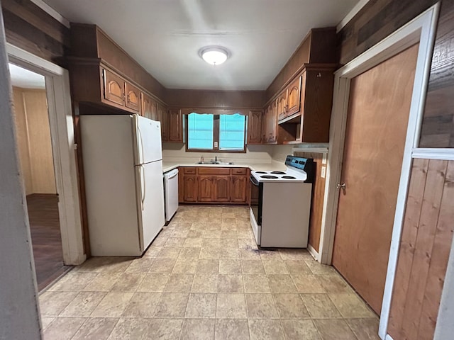 kitchen featuring white appliances and sink