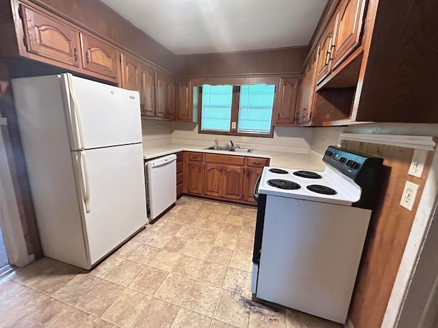 kitchen featuring white appliances and sink