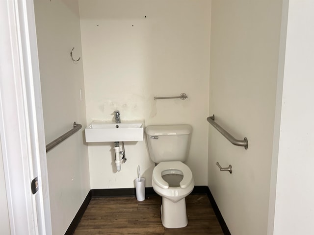 bathroom with hardwood / wood-style flooring and toilet