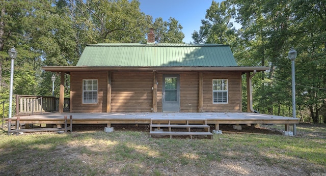 back of property featuring a deck