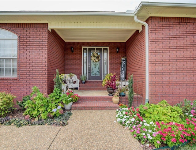 view of exterior entry featuring covered porch