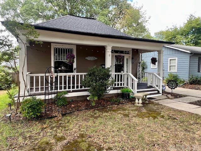 bungalow-style house with covered porch and a shingled roof