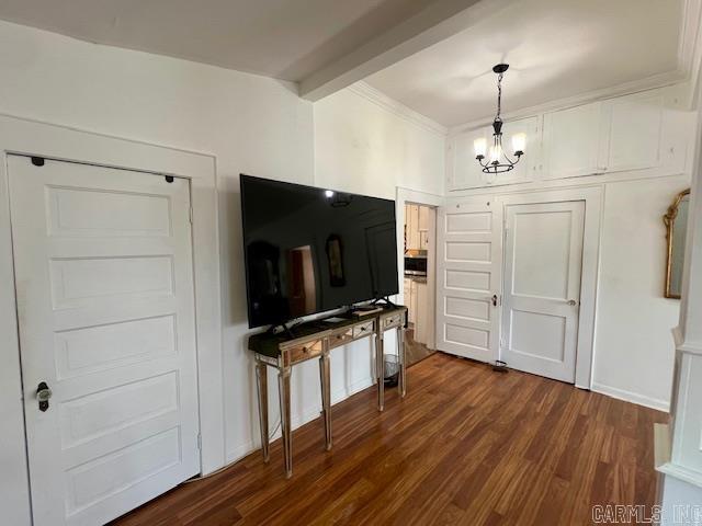 kitchen with stainless steel appliances, dark wood finished floors, white cabinetry, and crown molding