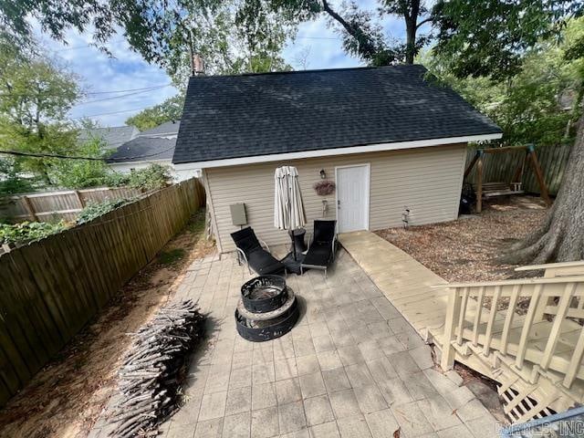 view of patio featuring a fenced backyard and a fire pit